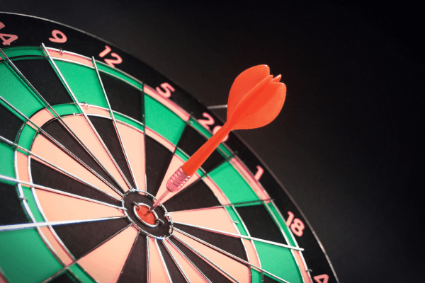 Target icon with arrow hitting bullseye, AI graph background